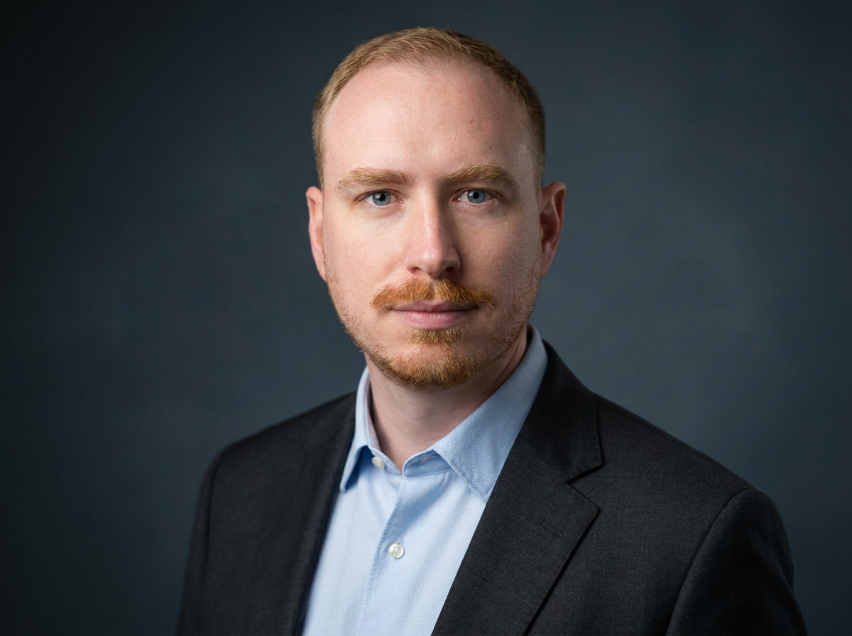Pierre Jereczek, operator and COO, photographed shoulders-up against a plain dark background, looking straight to camera.